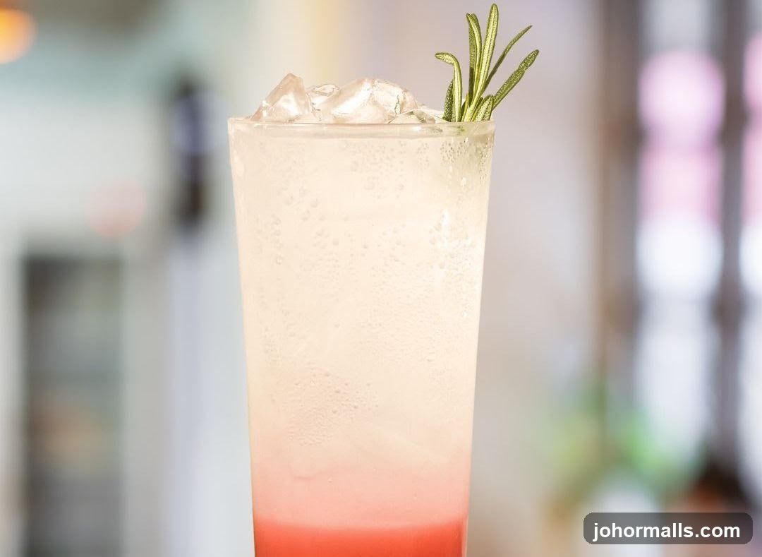 Pink and White Drink with Rosemary Garnish