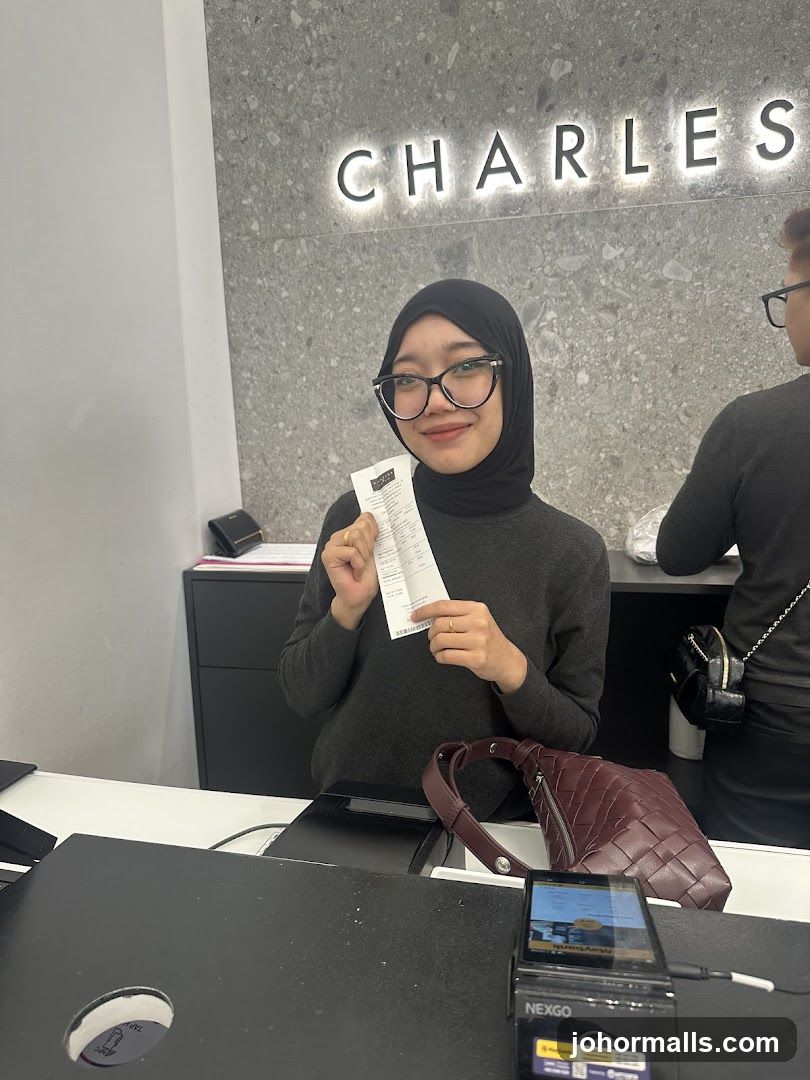 Woman holding a receipt at a counter