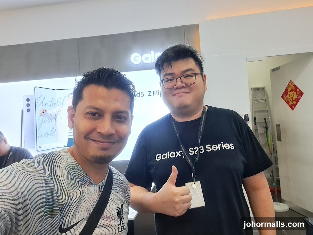 Two men posing for a photo in a store