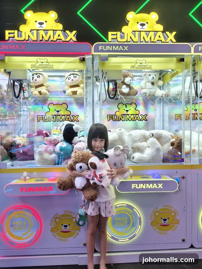 Girl with stuffed animals in front of claw machines