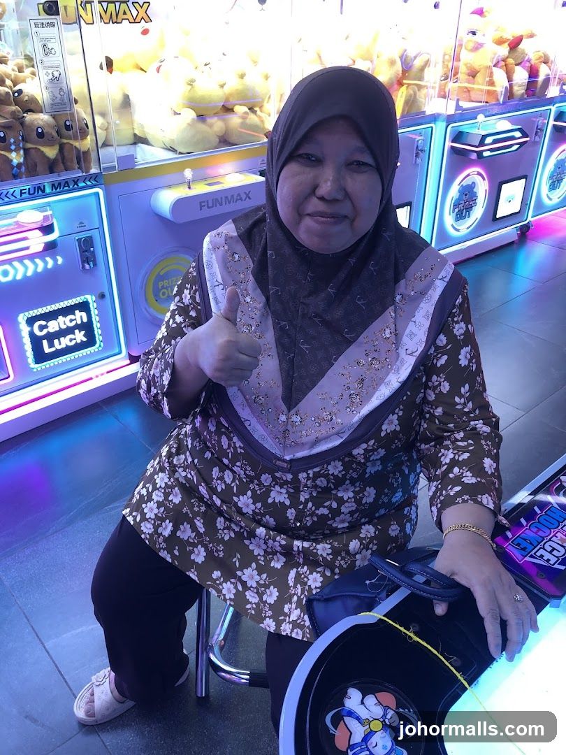 Woman giving a thumbs up in an arcade