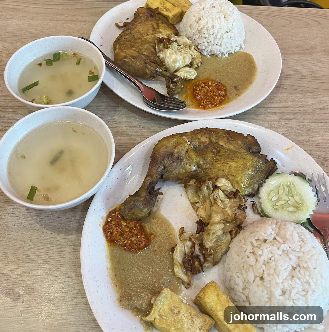 Two plates of fried chicken with rice and soup