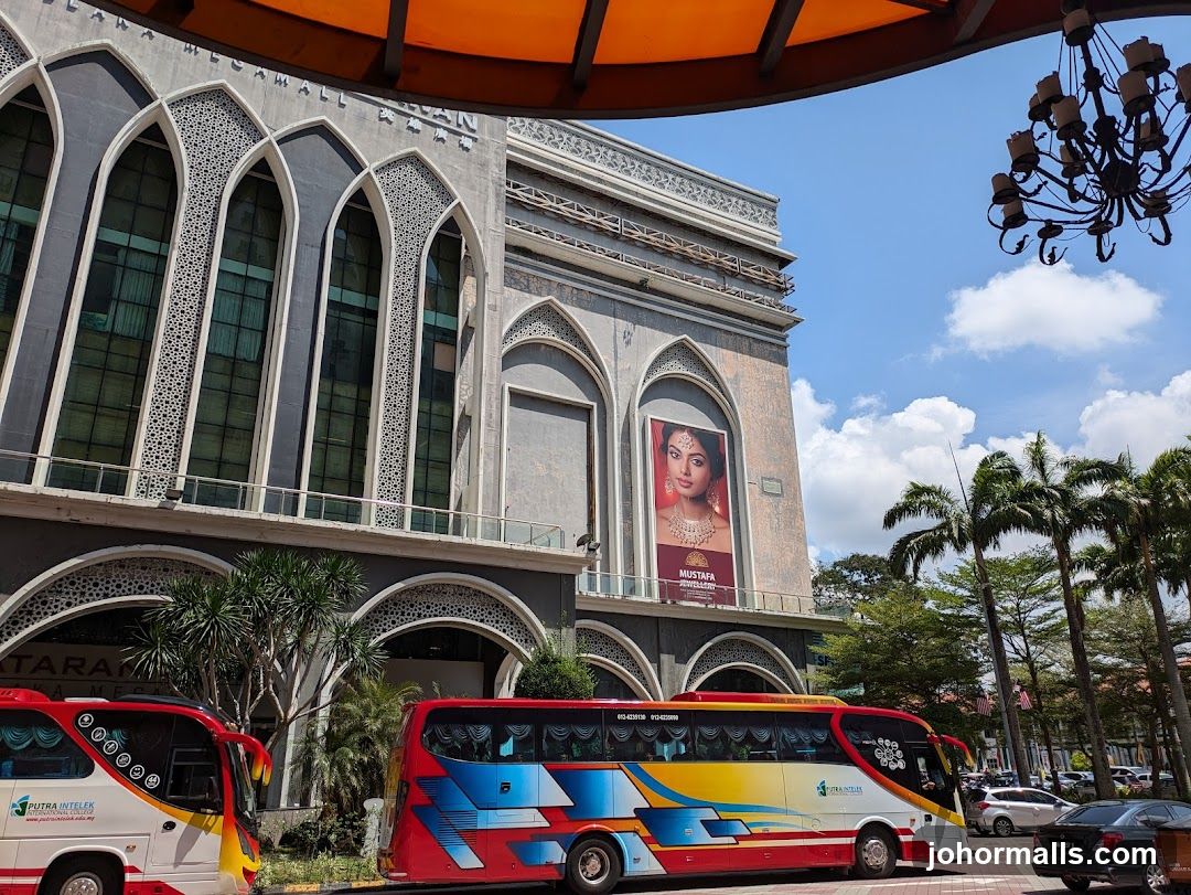 Mall Facade with Buses and Palm Trees