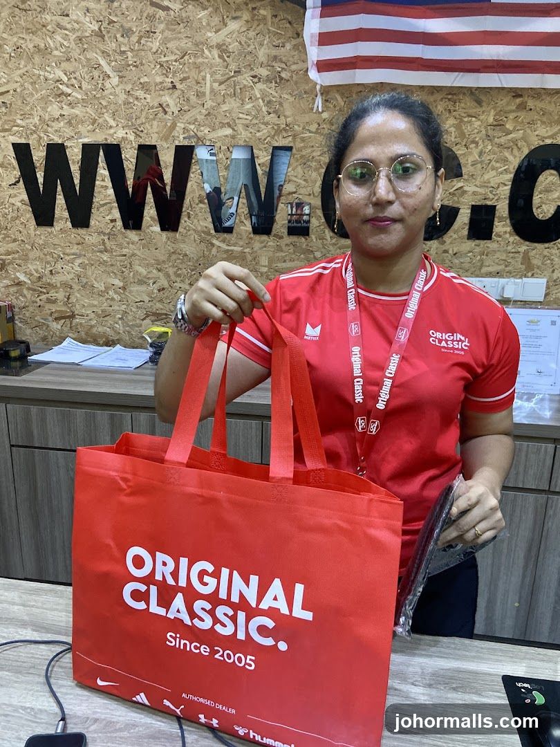 Woman holding a branded tote bag