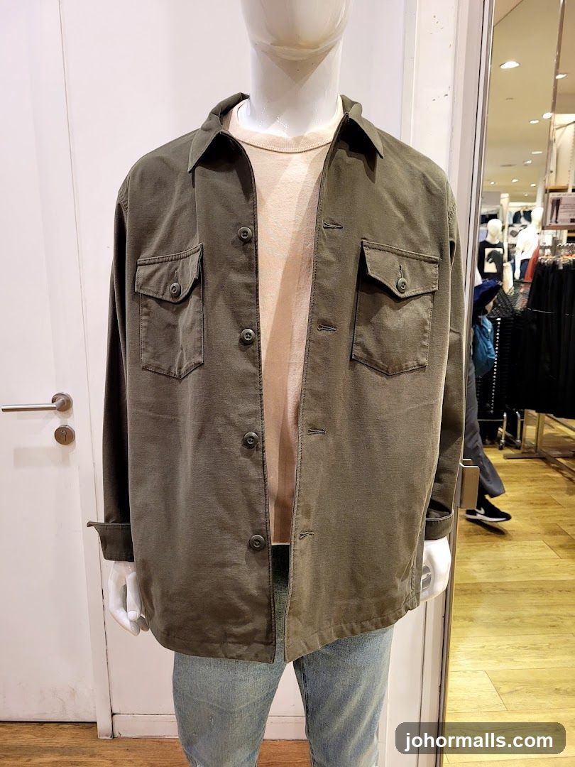 Mannequin wearing a green jacket and light pink t-shirt