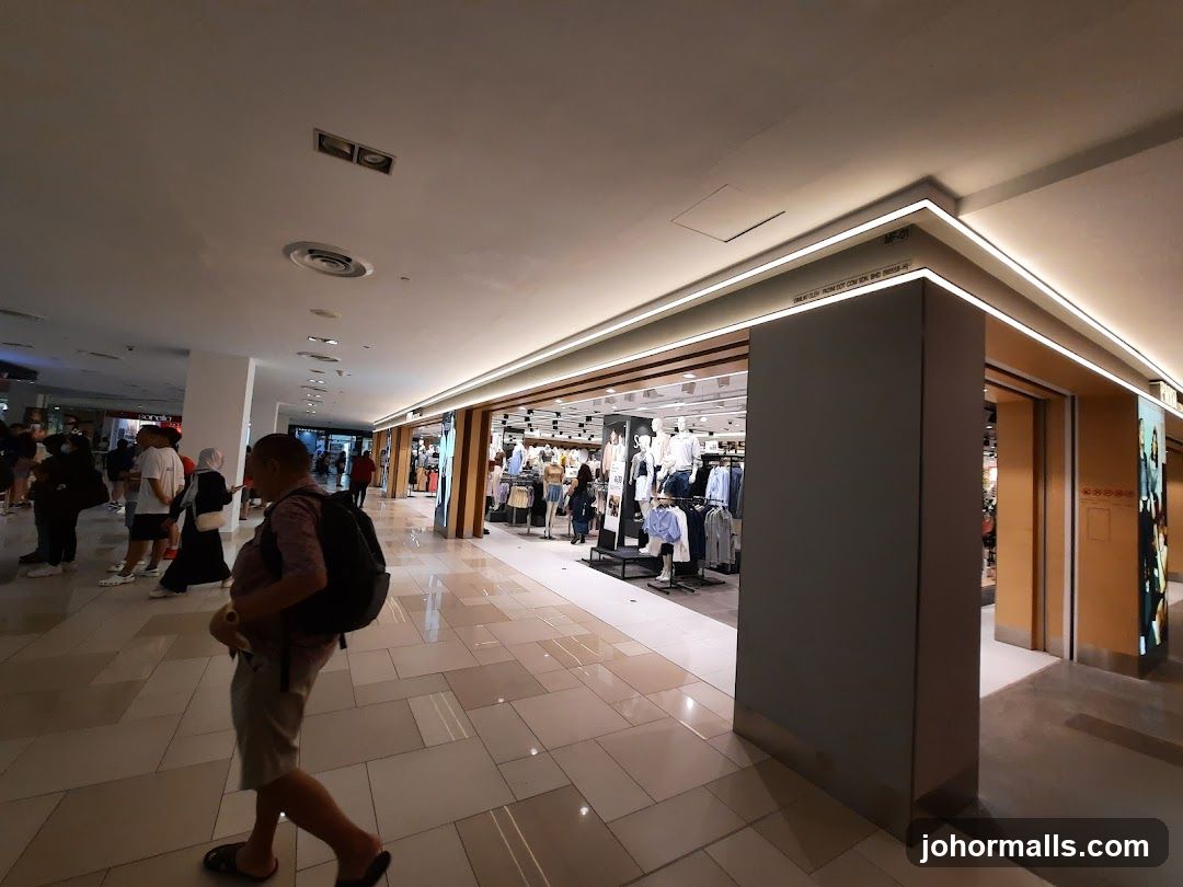 Clothing store interior with mannequins and shoppers