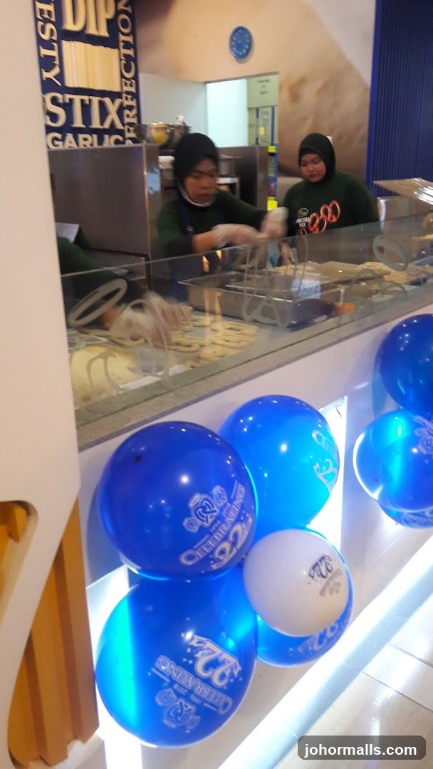 Food Preparation Area with Staff and Balloons