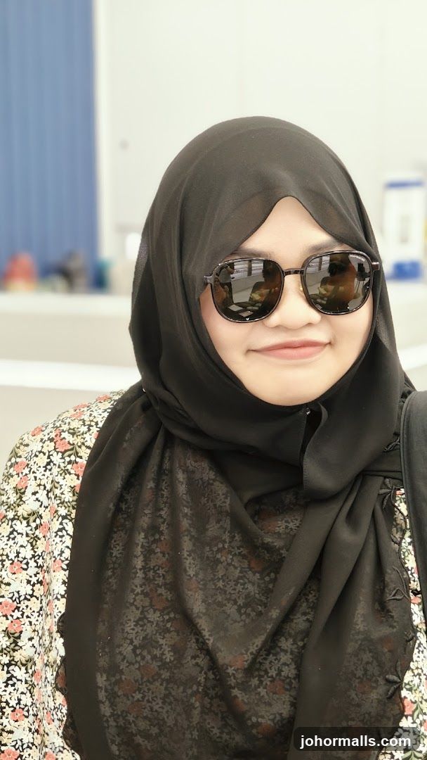 Woman wearing a hijab and sunglasses