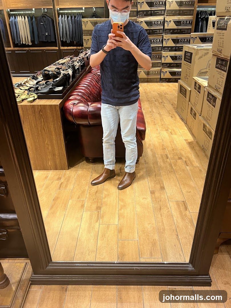 Man trying on boots in a store