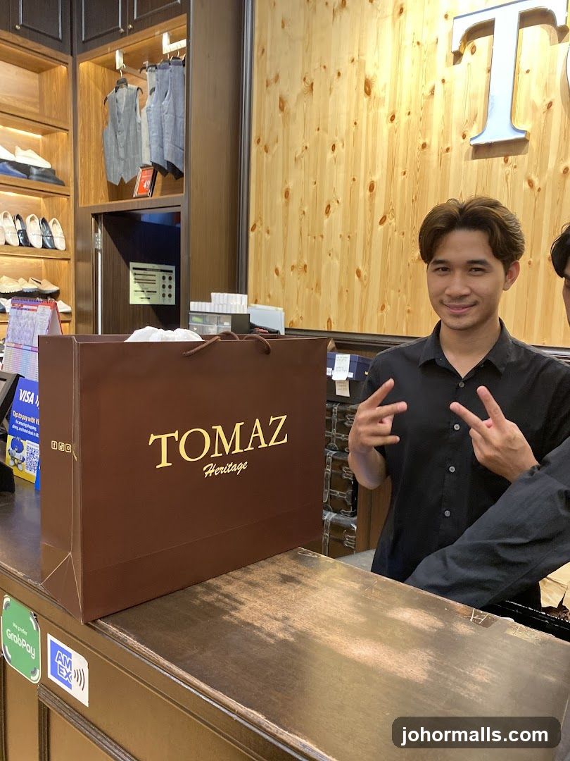 Man at a counter with a shopping bag