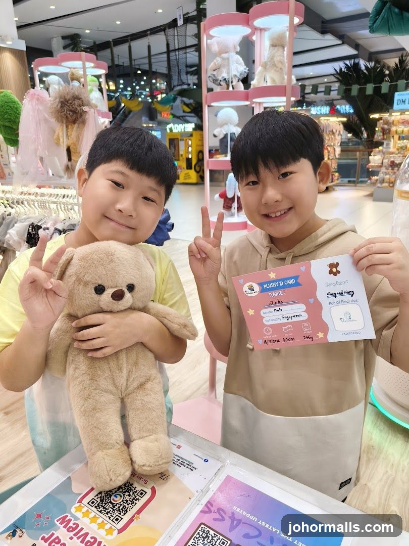 Two boys with a teddy bear and a plushy ID card
