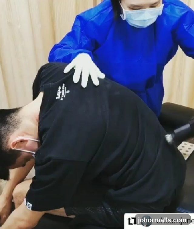 Therapist adjusting patient's back