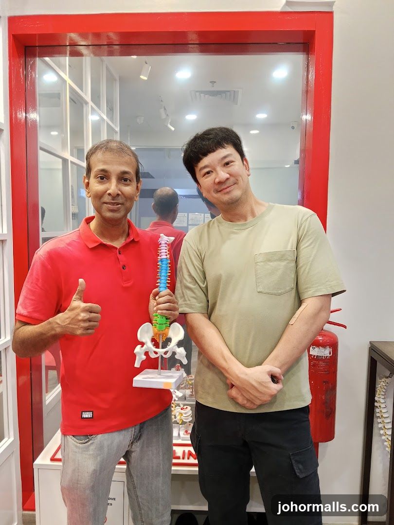 Two men with a spine model