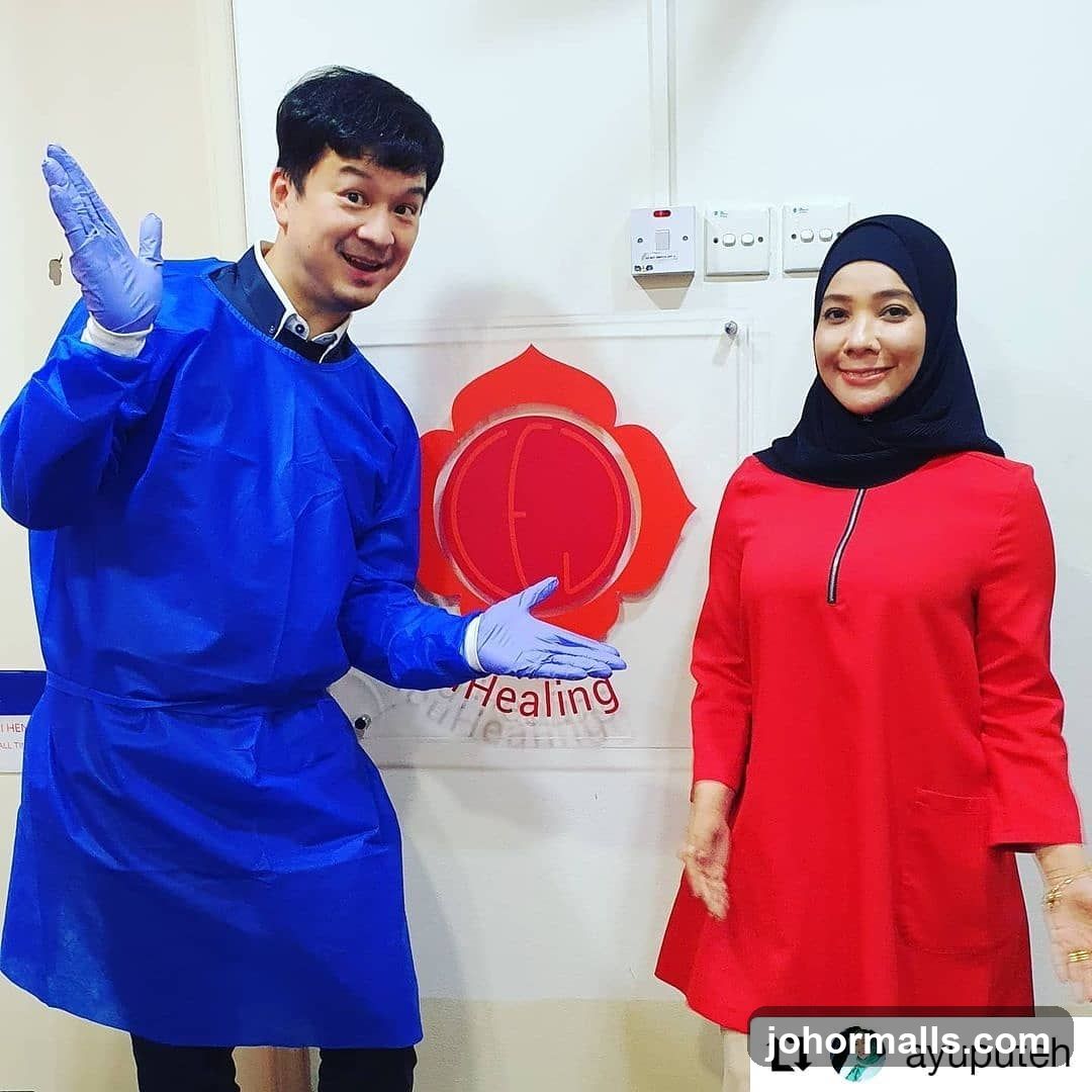 Two people in front of a logo