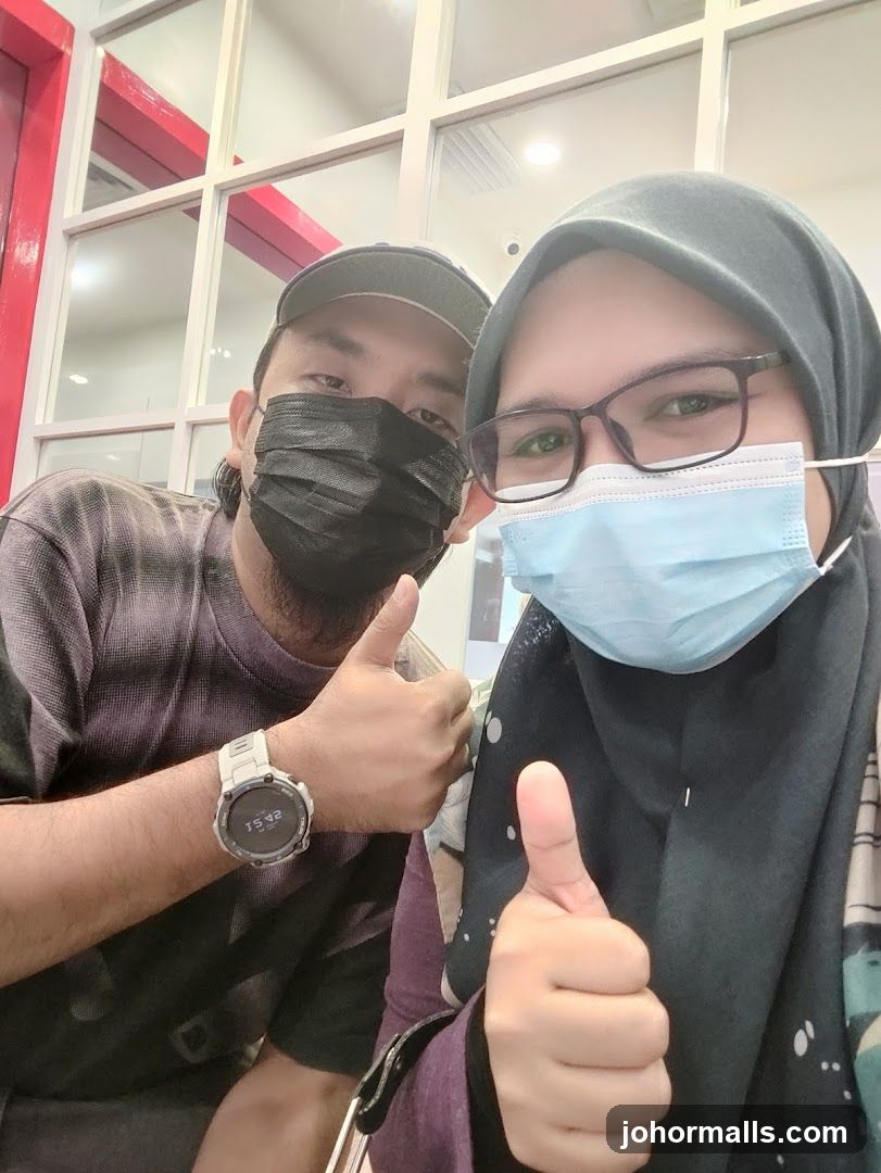 Two people giving thumbs up