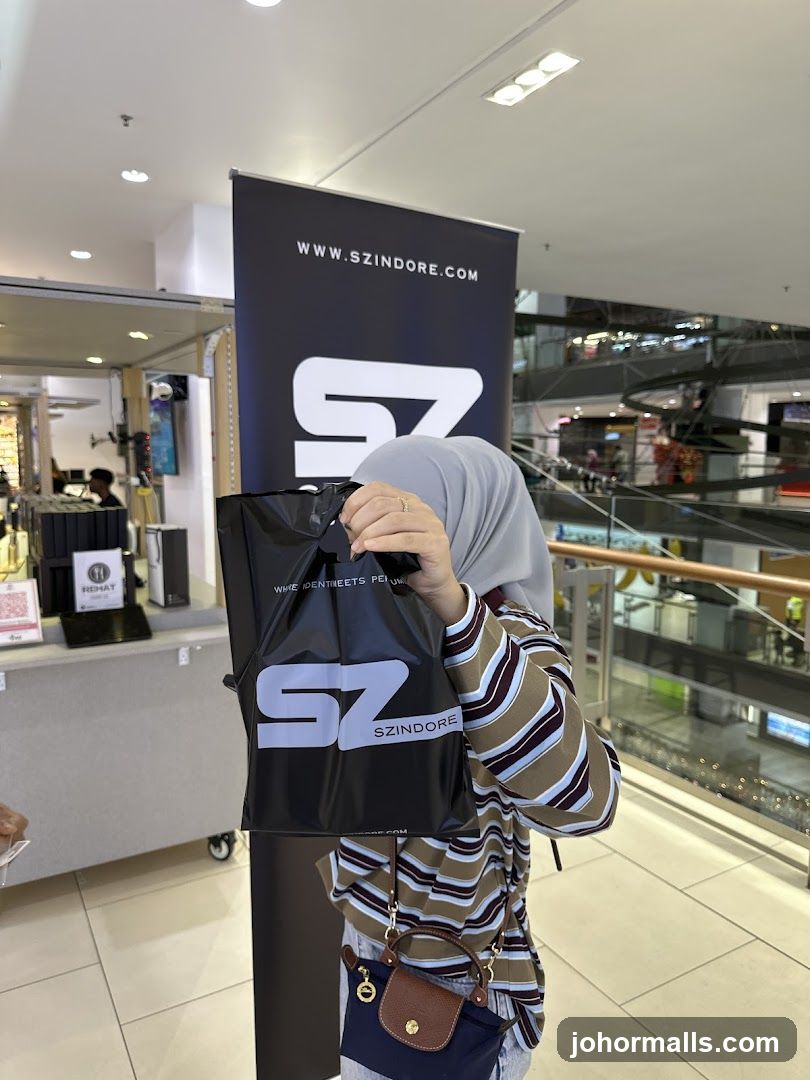 Woman holding a shopping bag with a logo