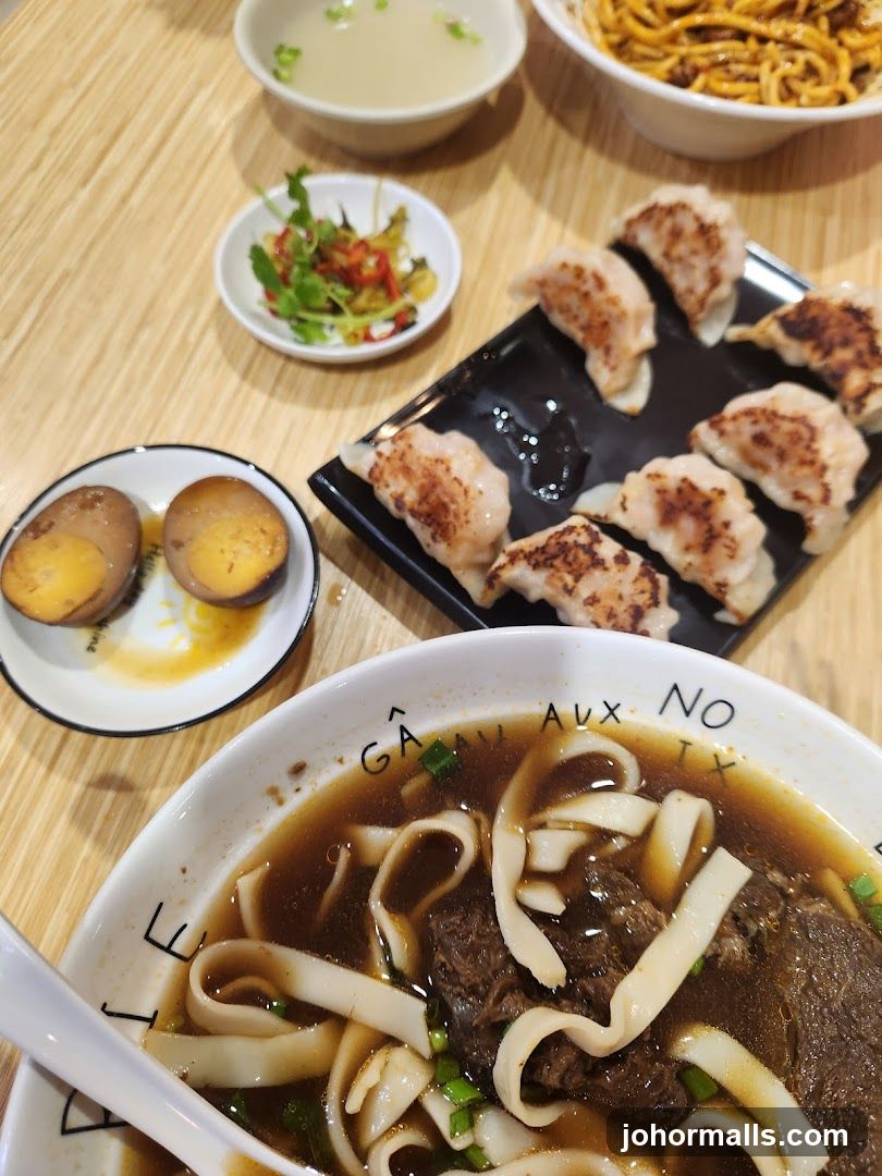 Beef noodle soup with dumplings and side dishes