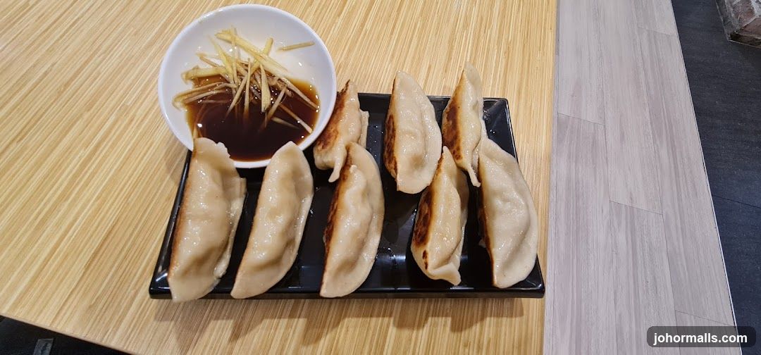 Pan-fried dumplings with dipping sauce