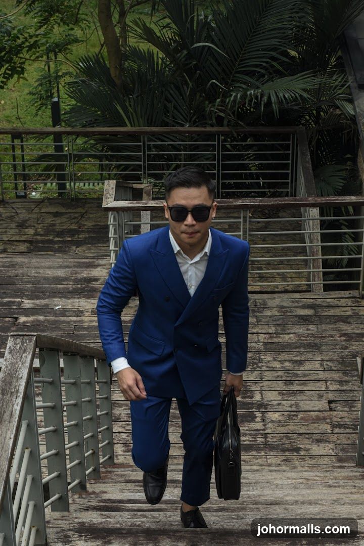 Man in Blue Suit Walking Up Stairs