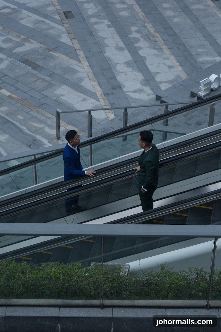 Two businessmen on an escalator