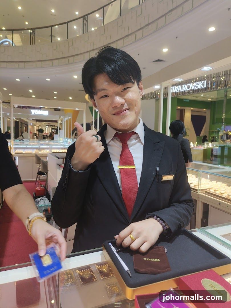 Jewelry store employee with gold bar