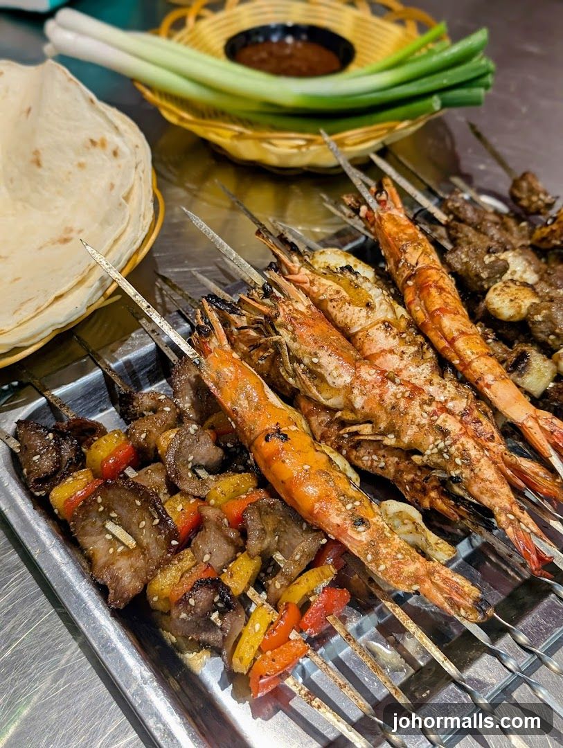 Skewers of grilled shrimp and meat with vegetables