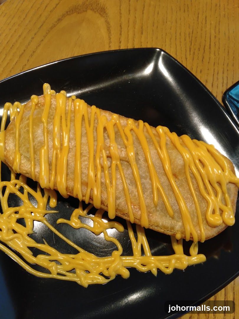 Fried pastry with cheese sauce