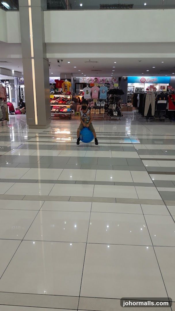 Boy on a bouncy ball in a mall