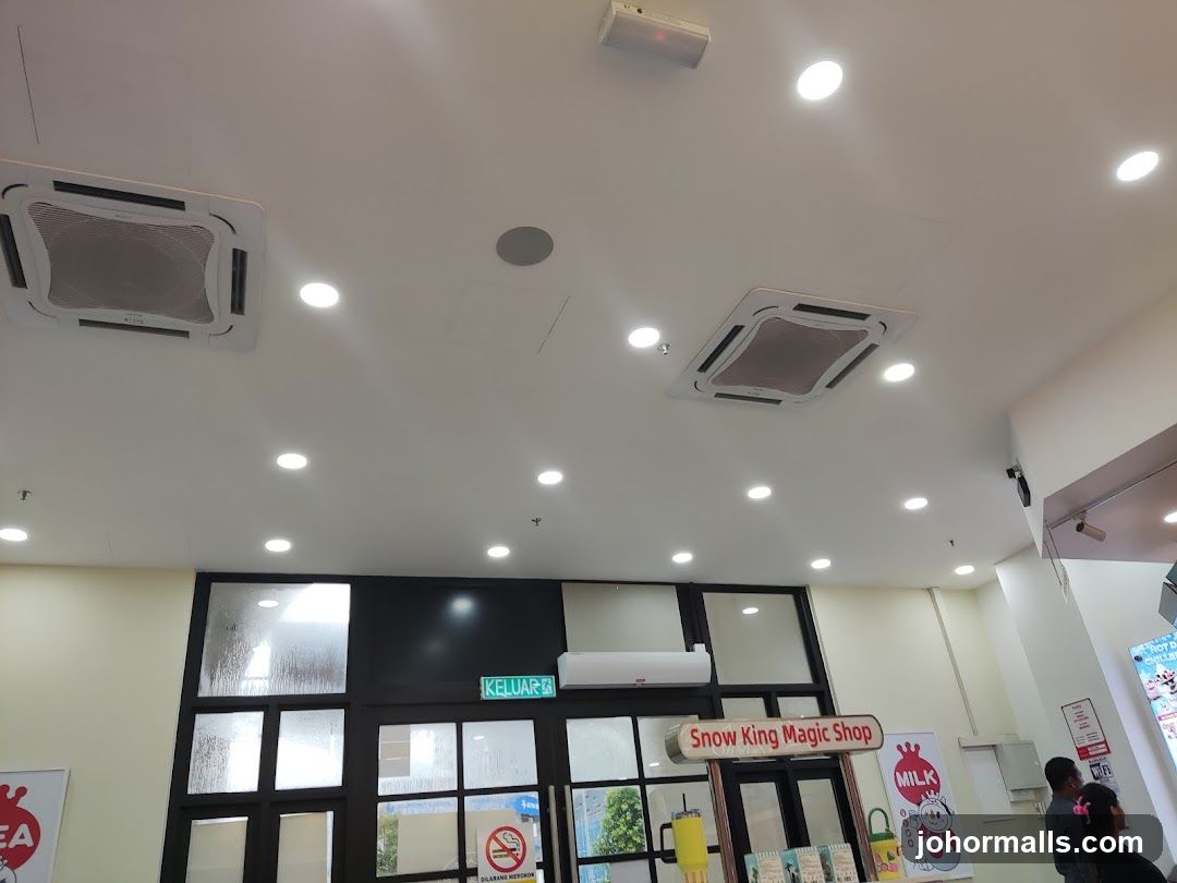Interior of a shop with air conditioning units and signage