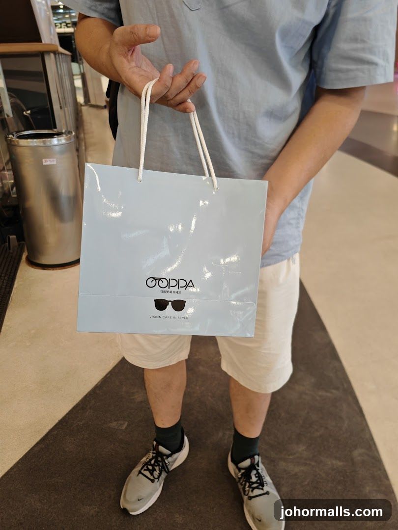 Person Holding Shopping Bag