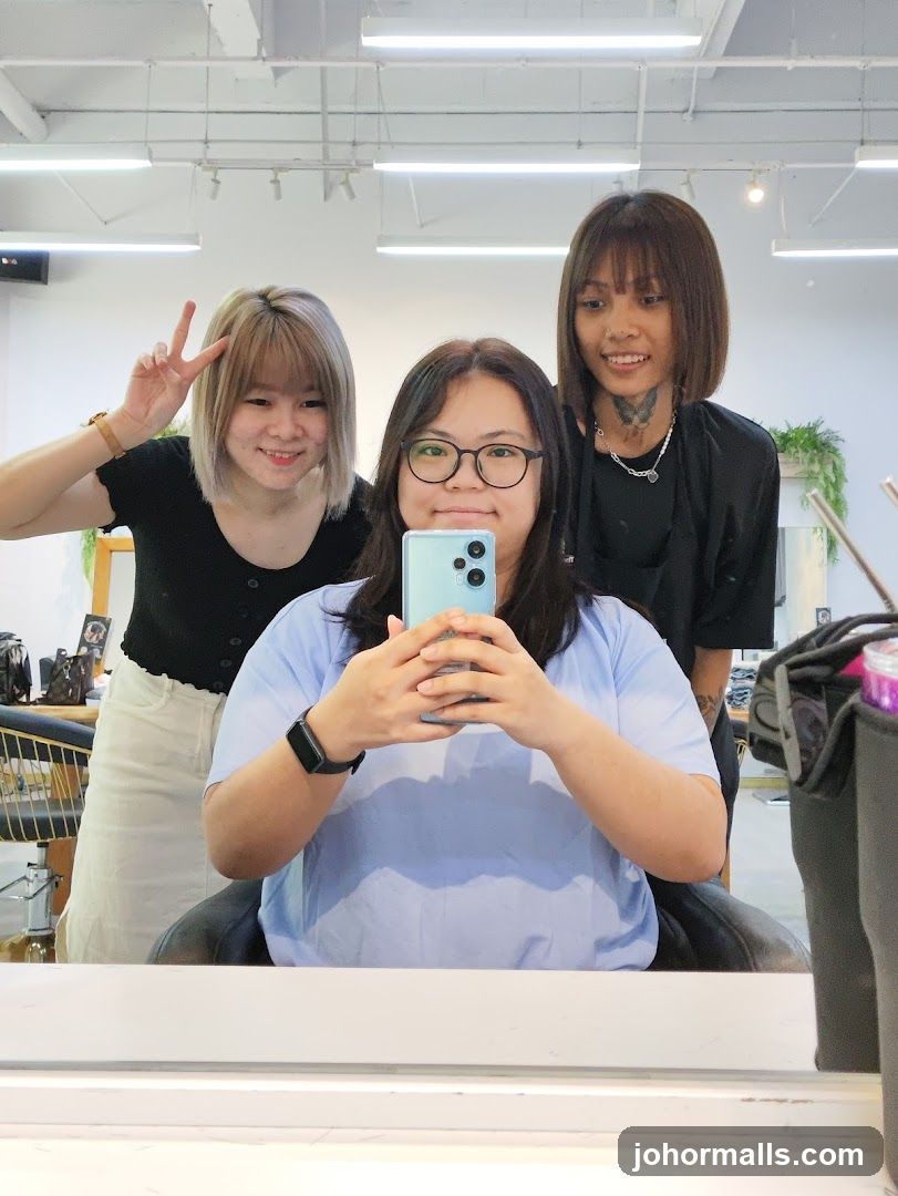 Three people taking a selfie in a salon
