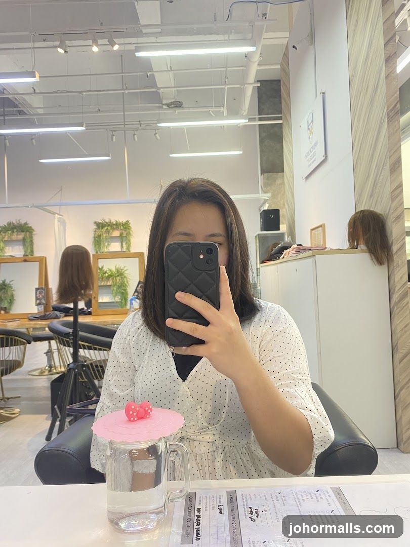 Woman taking a selfie in a salon