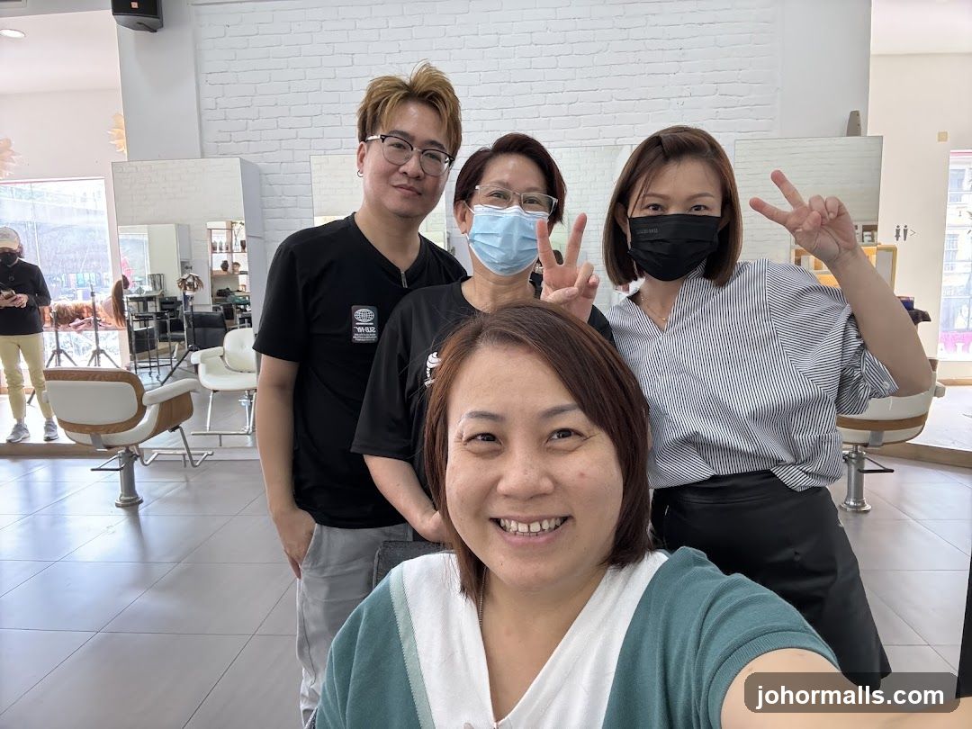 Four people posing for a selfie in a salon