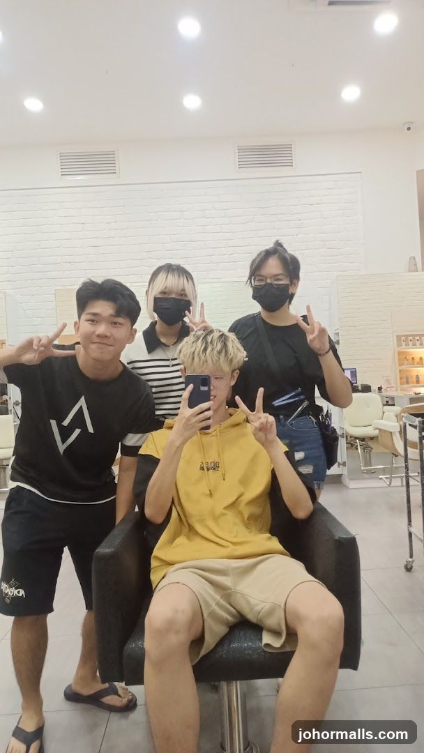 Four people posing for a photo in a salon