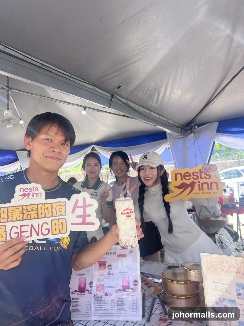 People posing with drinks and signs