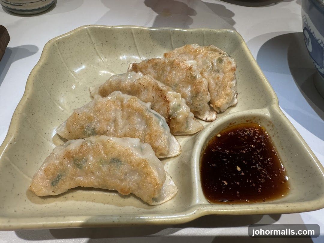 Pan-fried dumplings with dipping sauce