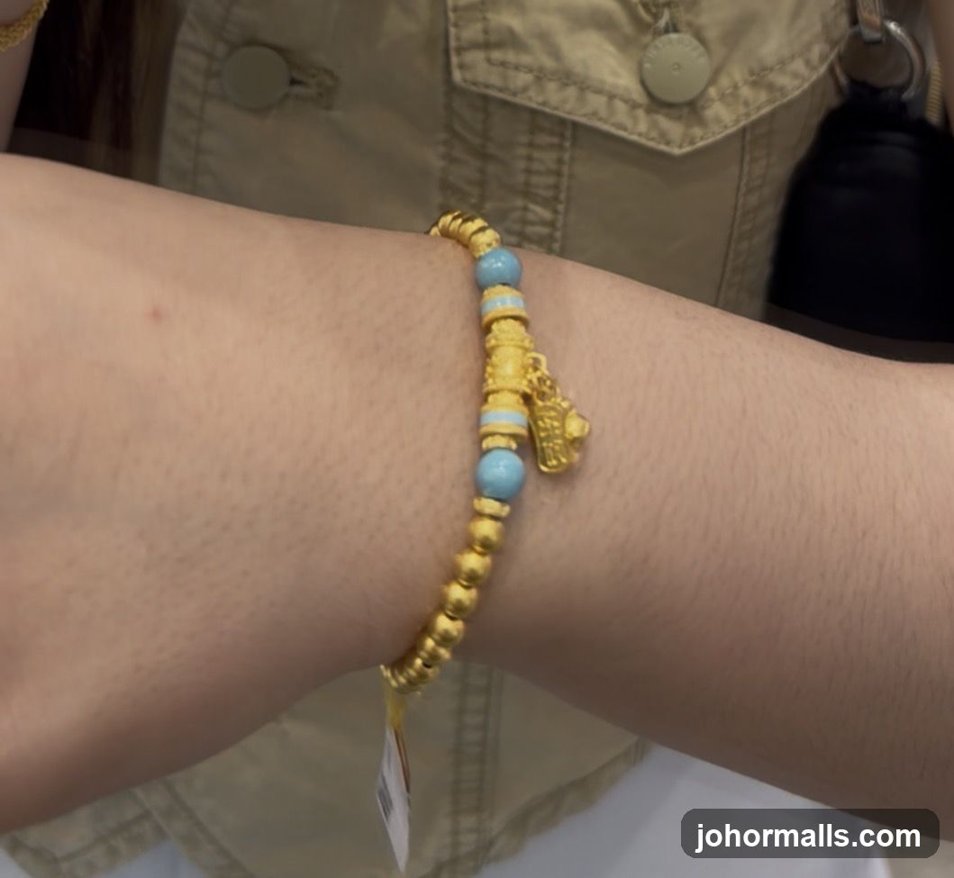 Gold bracelet with blue beads and a charm