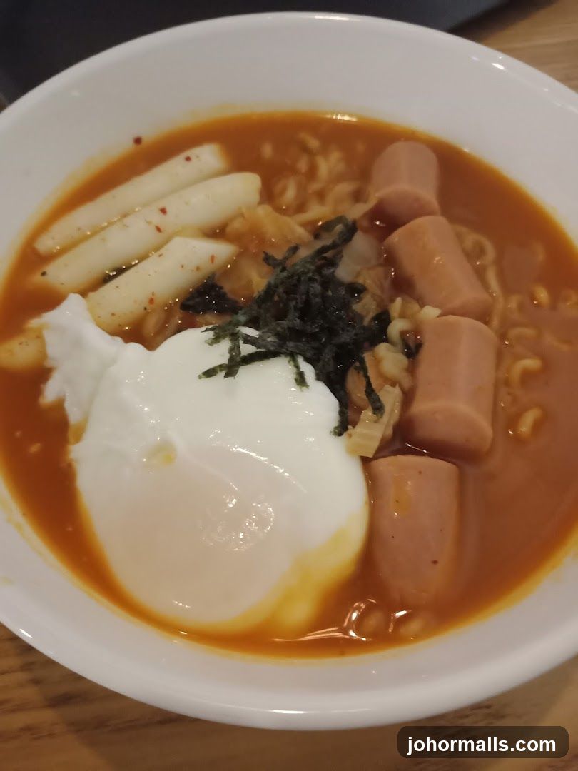 Spicy Noodle Soup with Egg and Sausages