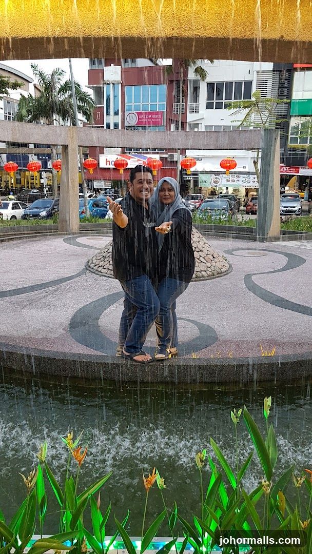 Couple Posing in a Fountain