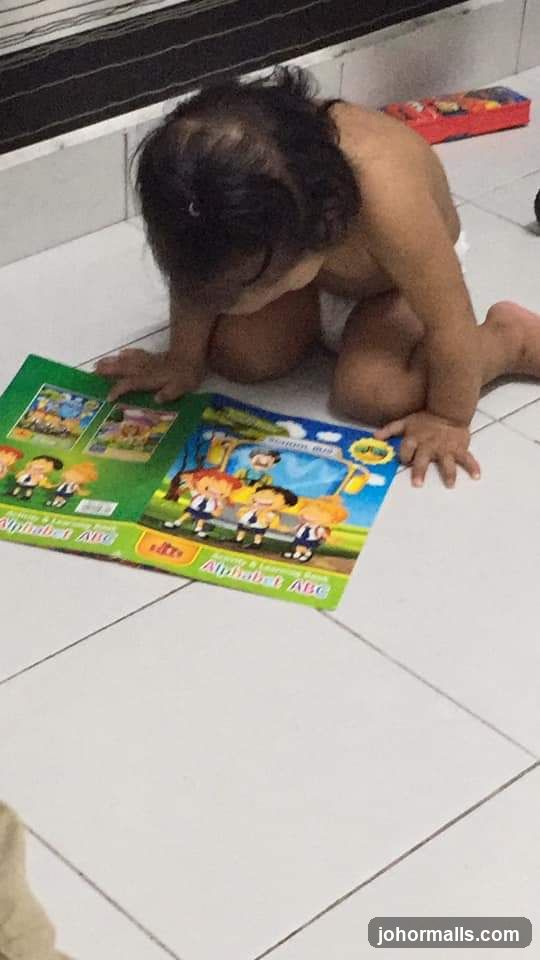 Child reading an alphabet book