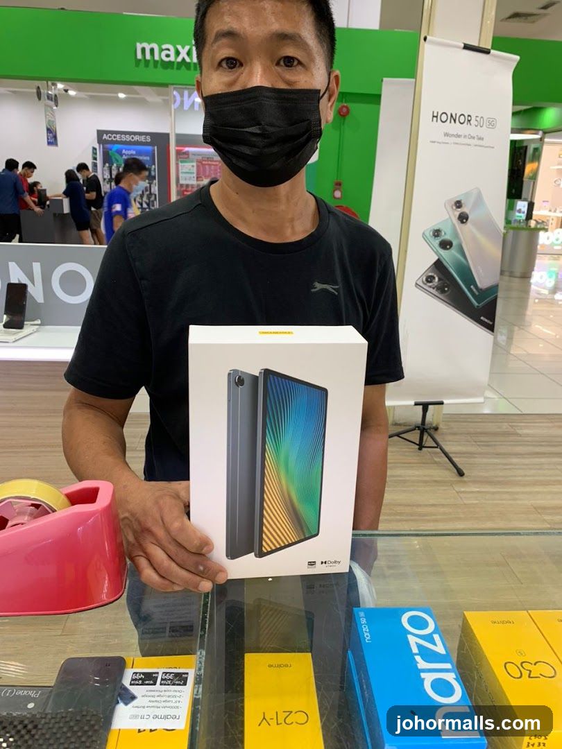 Man holding a tablet box in a store