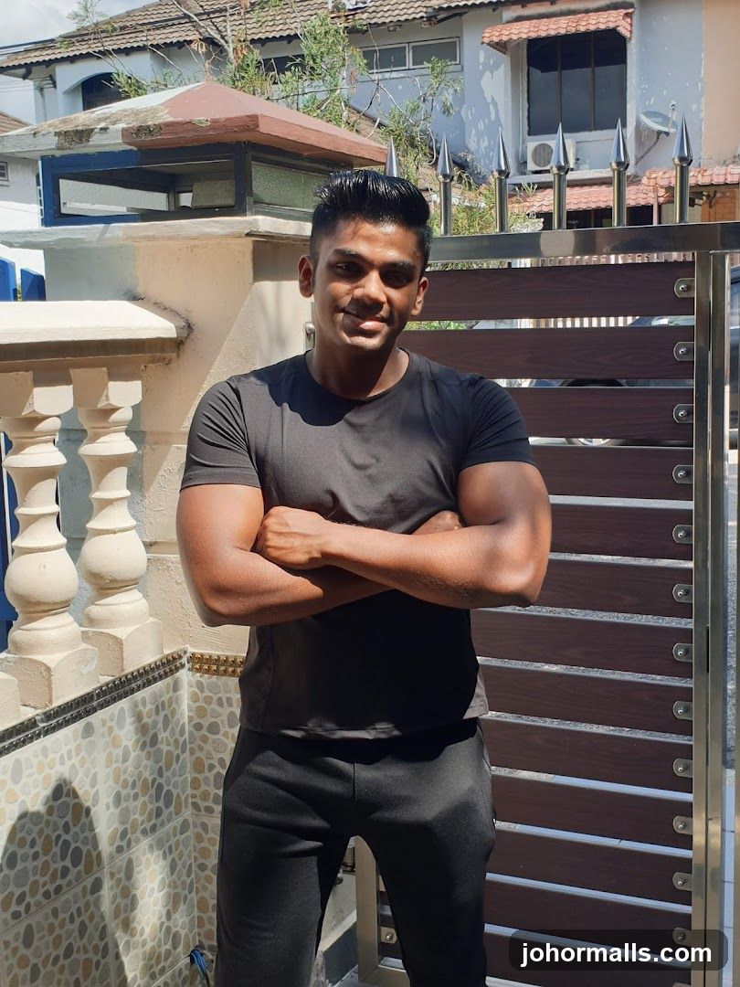 Man posing in front of a gate