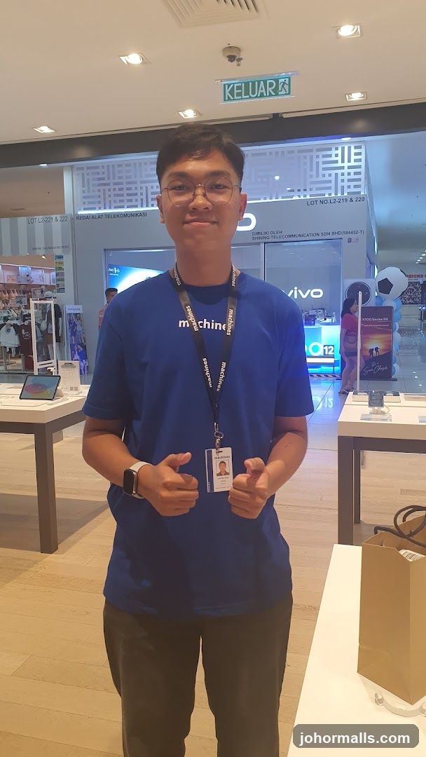 Store employee in blue shirt