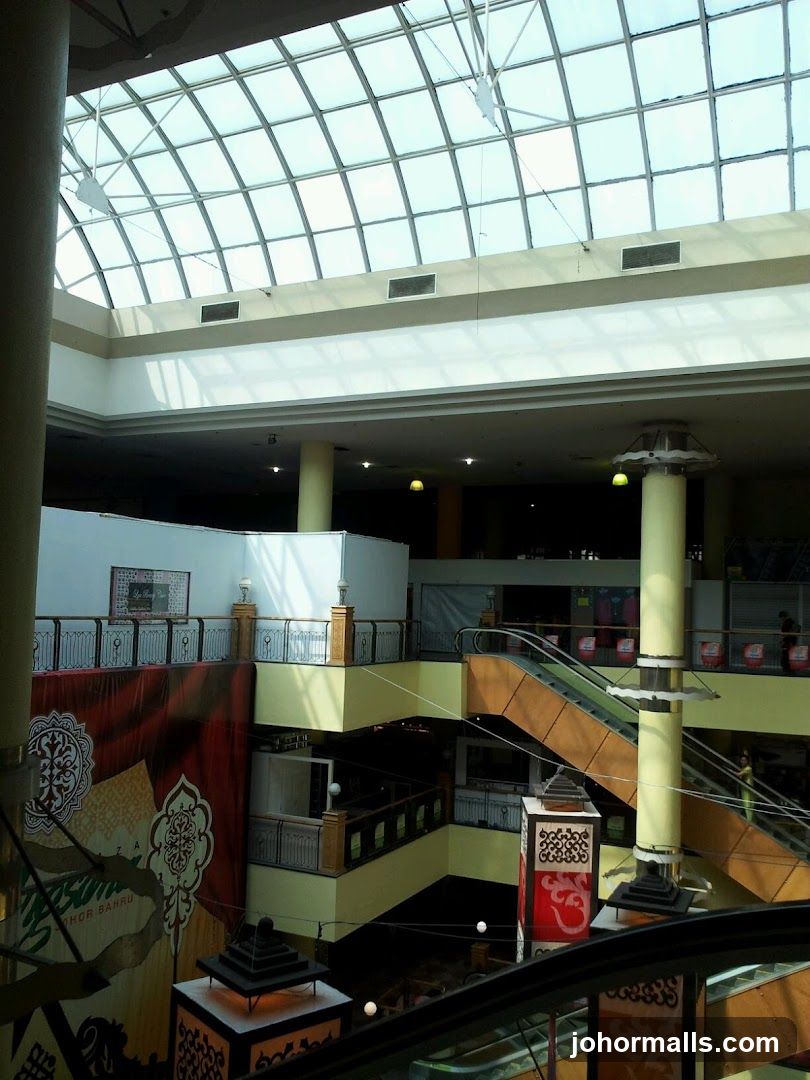 Interior of a multi-level shopping mall with a glass ceiling