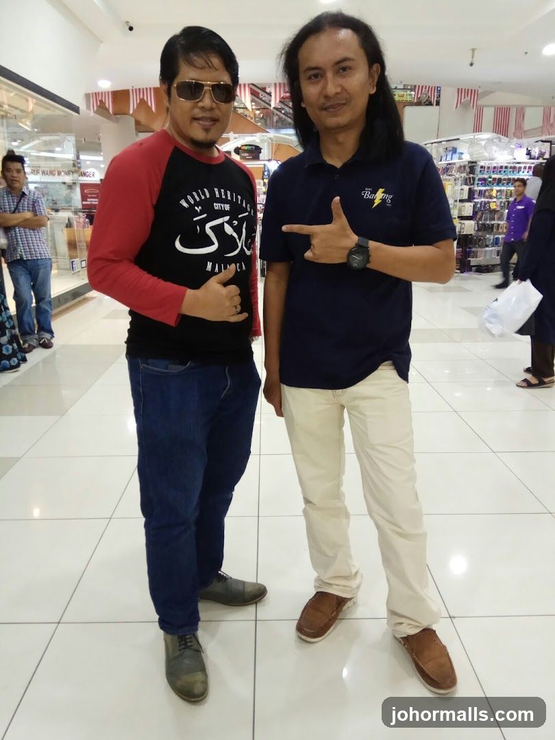 Two men posing in a mall