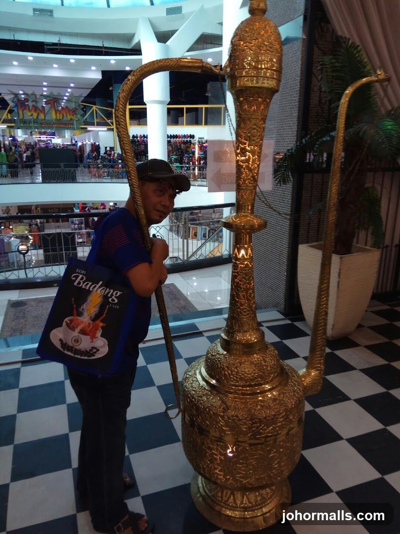 Man Posing with Large Golden Hookah Pipe