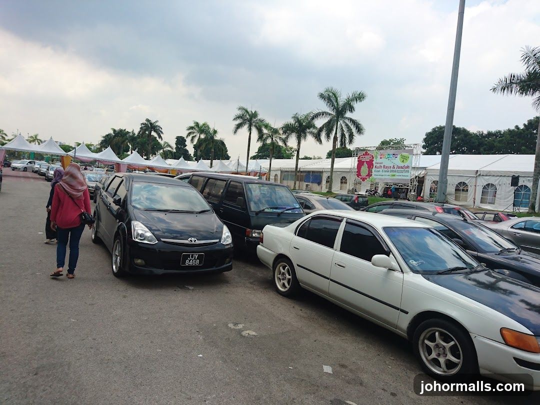 Outdoor Event with Tents and Cars