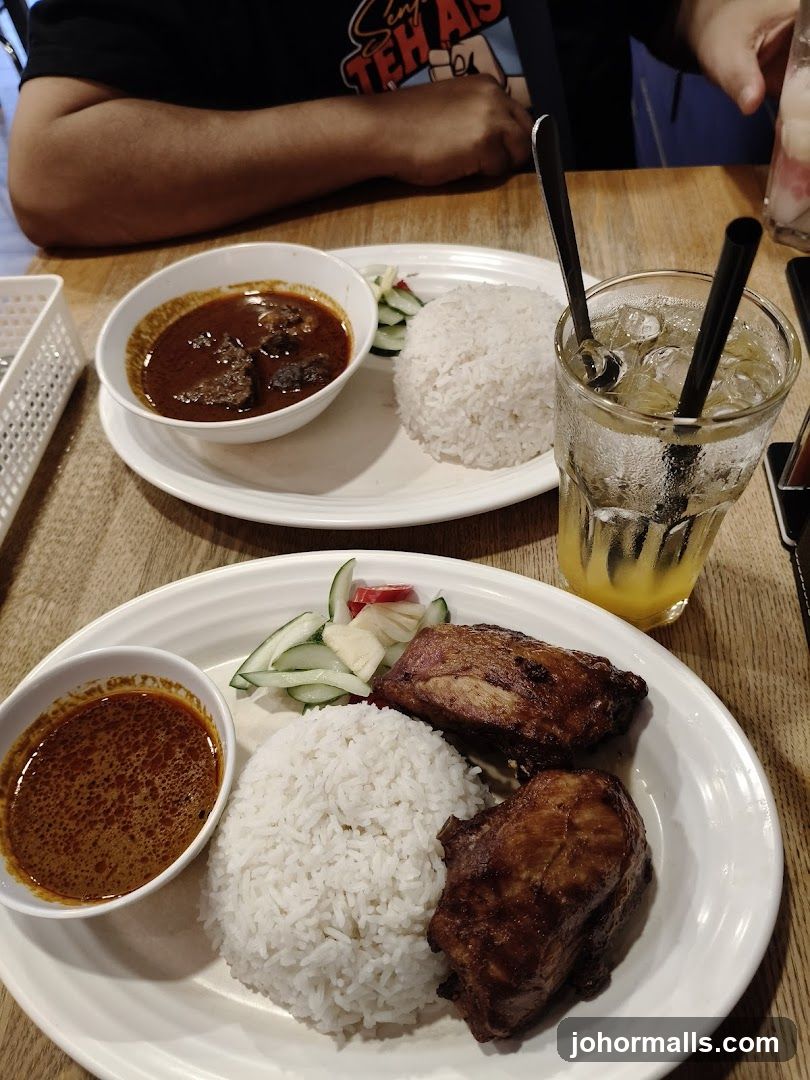 Two plates of rice with meat and sauce