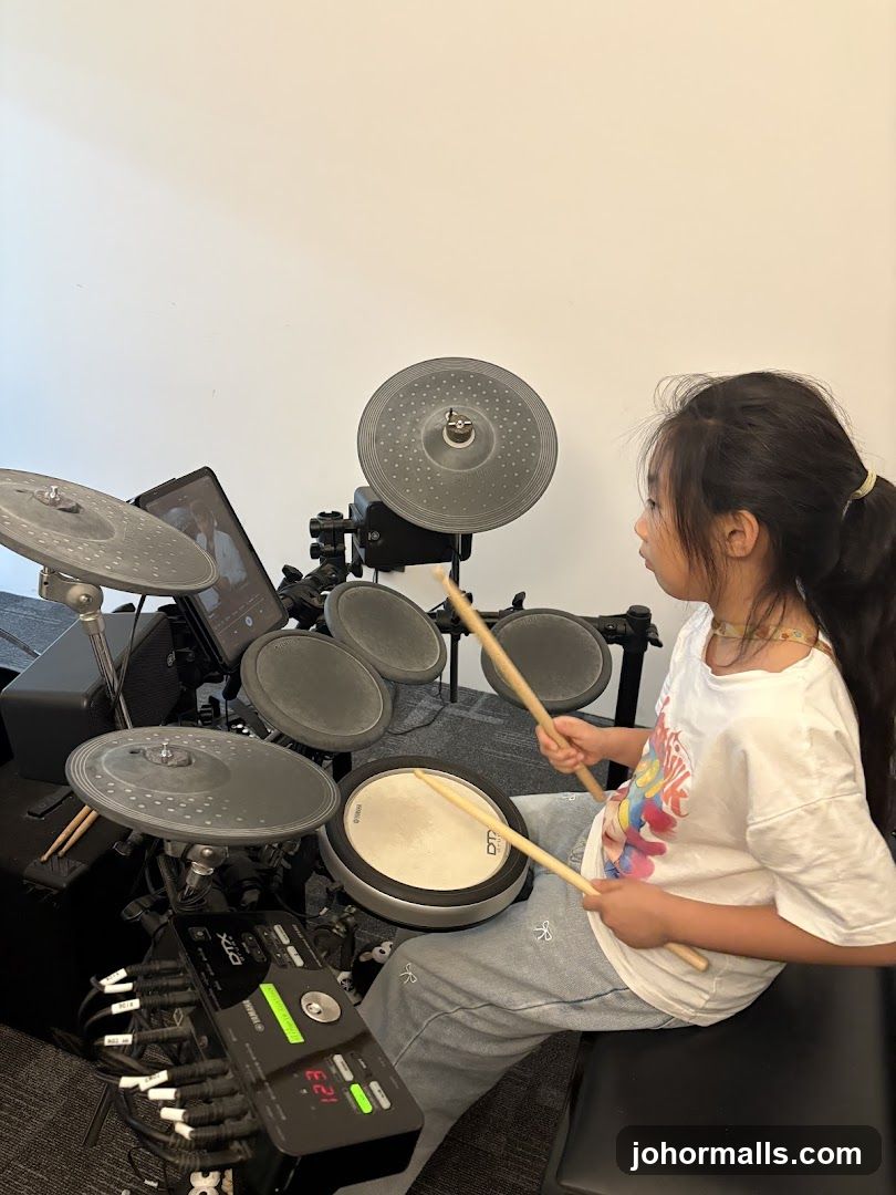 Young girl playing electronic drums