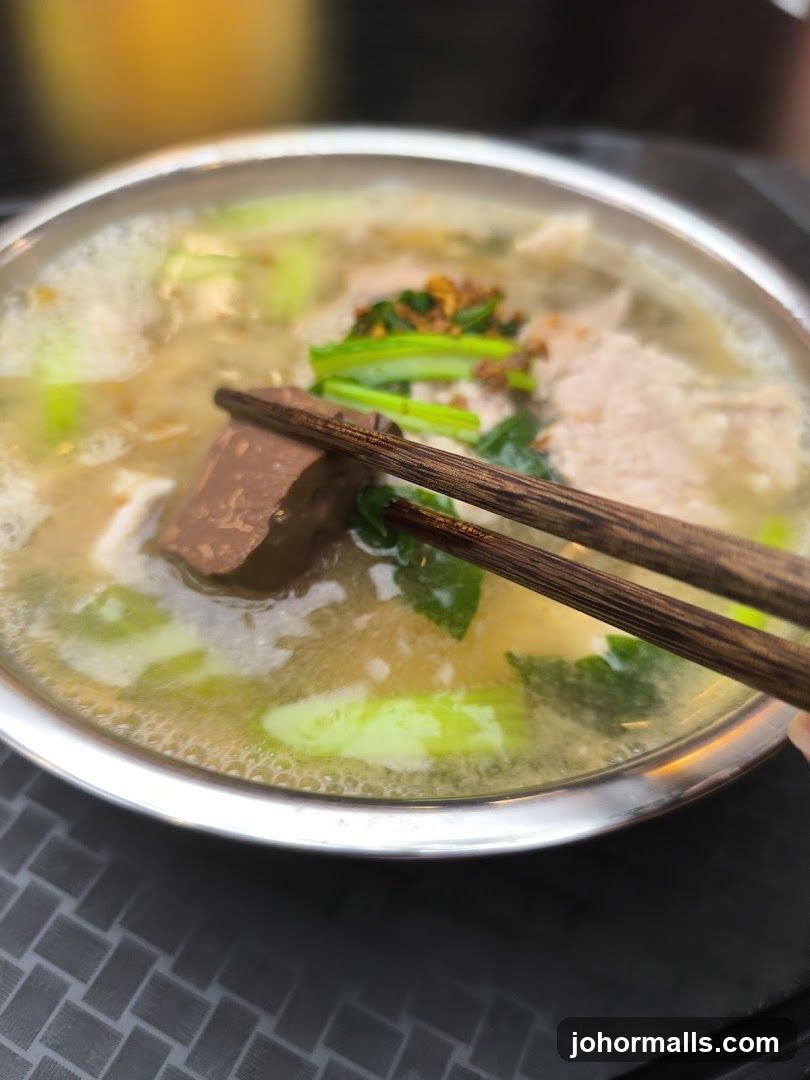 Bowl of Soup with Blood Cake and Vegetables
